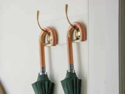 two green umbrellas hanging on a wall at Brewhouse Flat - Culzean Castle in Maybole