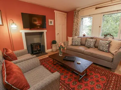 a living room with a couch and a table at The Coach House - Holmwood in Glasgow