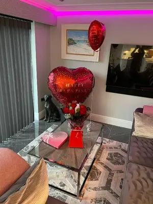 a living room with a heart balloon on a table at Little Fox Lodge Luxury Hideaway with Hot Tub Glencoe Near Fortwilliam in Glencoe