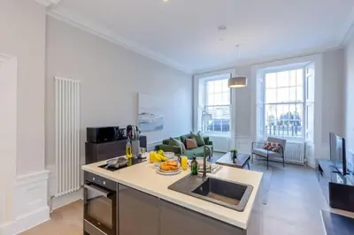 a kitchen and living room with a counter top at Dragon Suites - Edinburgh City Centre 1 Bed Apartment in Edinburgh