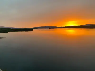a sunset over a body of water at 4 Dolphins in Connel