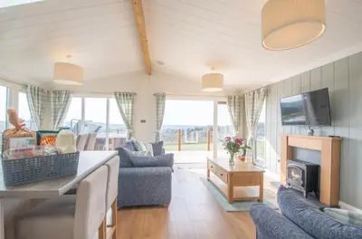 a living room with a couch and a tv at 2 Bedroom Sleeps 4 Lodge-Smart Tv-Hot tub-Dogs Ok in Lochwinnoch