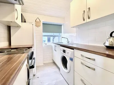 a kitchen with a washer and dryer in it at Kingsbridge Apartment in Glasgow