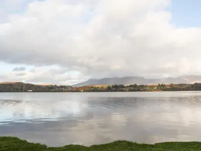 a view of a lake with mountains in the background at Burnside House in Dalmally