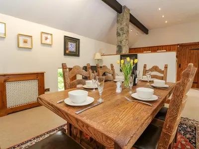 a dining room with a wooden table and chairs at The Steading in Dalmally