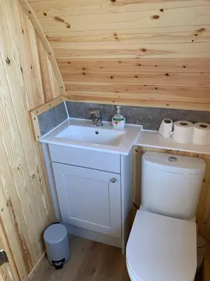 a small bathroom with a sink and a toilet at The Stag Pod Farm Stay with Hot Tub Sleeps 2 in Galston
