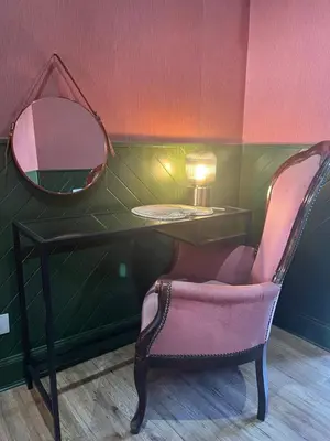a dressing table with a chair and a mirror at Witchwood House in Oban