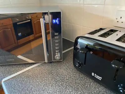a toaster oven sitting next to a microwave at Mawenyoupe in Lochgilphead