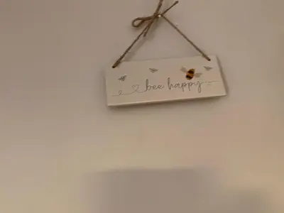 a sign that says a bee sanctuary hanging on a wall at Mawenyoupe in Lochgilphead