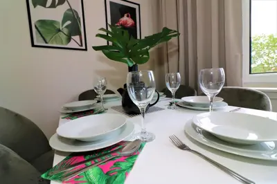 a table with plates and wine glasses on it at Macintosh Upper in Bellshill