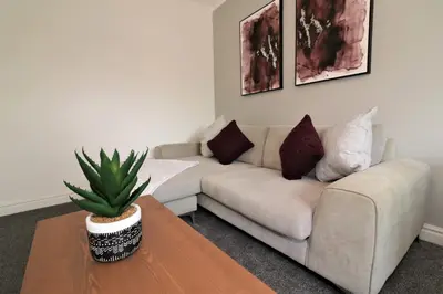 a living room with a couch and a table at Macintosh lower in Bellshill