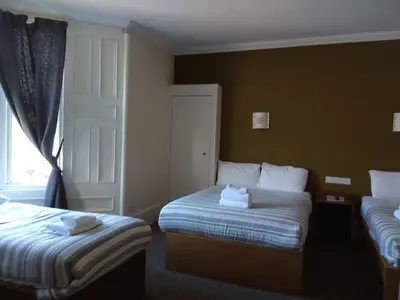 a hotel room with two beds and a window at Glasgow House in Glasgow