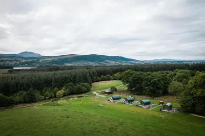 an aerial view of a farm with tents in a field at Cardross Estate Glamping Pods in Stirling