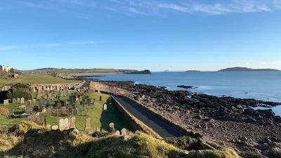 a view of a cemetery next to the ocean at Osborne Cottage in Southend