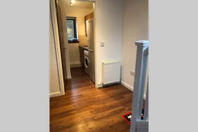 a hallway with a room with a bathroom and a hallway at Struan Coach house in gated residence in Stirling