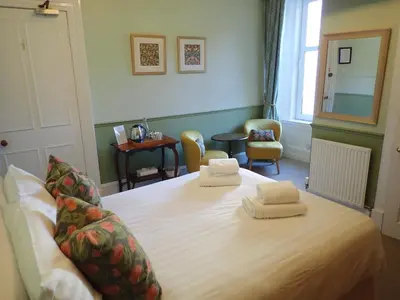 a bedroom with a bed with two towels on it at Hawthornbank in Oban