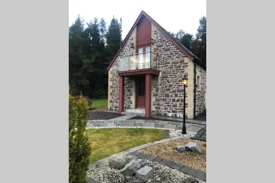 a stone house with a pathway leading to it at Private Coach house in gated residence in Stirling