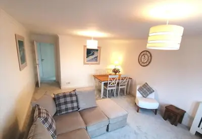 a living room with a couch and a table at Seaside Apartment in Oban