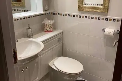 a white bathroom with a toilet and a sink at 1 Bed House - Central Free Parking Wifi in Stirling