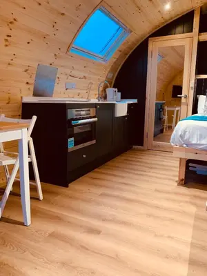 a bedroom with a bed and a desk and a window at Thistle Pod Farm Stay with Hottub Sleeps 2 in Galston