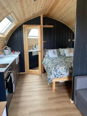 a bedroom with a bed in a tiny house at Thistle Pod Farm Stay with Hottub Sleeps 2 in Galston