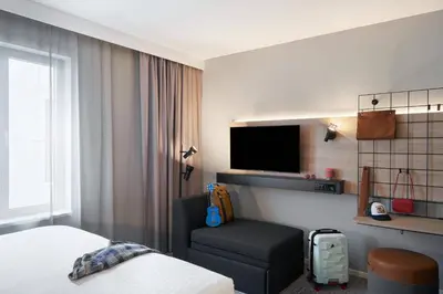 a hotel room with a bed and a tv at Moxy Edinburgh Fountainbridge in Edinburgh