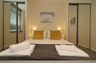 a bedroom with a large bed with two pillows at Signature - Railway Cottage in Maryhill