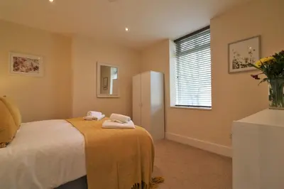 a bedroom with a bed with towels on it at Signature - Railway Cottage in Maryhill