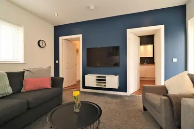 a living room with a couch and a tv at Signature - Railway Cottage in Maryhill