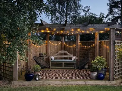 a gazebo with a bench and lights at Garden Studio in Biggar in Biggar