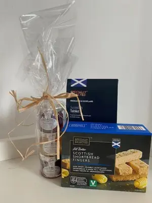 a box and a glass vase with some bread at Glenfinnan - Two Bedroom Apartment in Fife