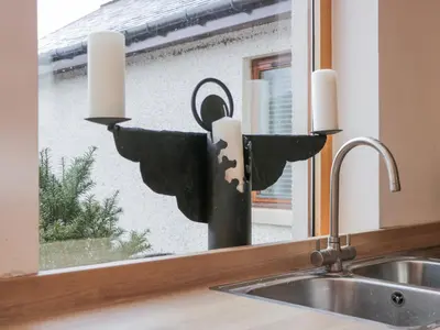 a candle holder sitting on top of a sink next to a window at Torview House in Peebles