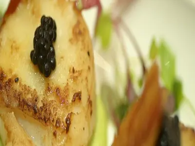 a piece of food with a black topping on top at Anchor Hotel and Seabed Restaurant in Tarbert
