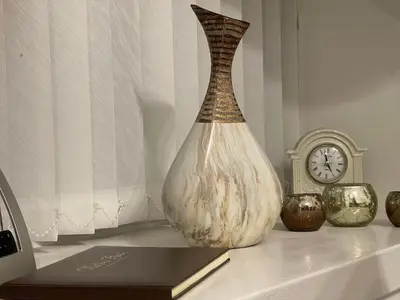 a vase sitting on a table next to a clock at HLA Holytown in Mossend