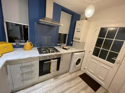 a kitchen with a stove top oven next to a dishwasher at HLA Holytown in Mossend
