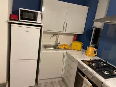 a kitchen with a white refrigerator and a microwave at HLA Holytown in Mossend