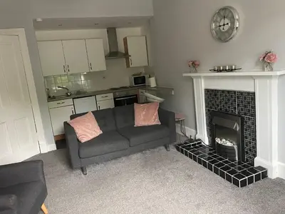 a living room with a couch and a fireplace at Our Wee Getaway in Rothesay