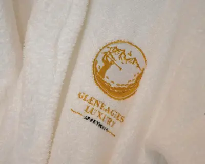 a white sweater with a logo on it at Gleneagles Luxury Apartments in Auchterarder