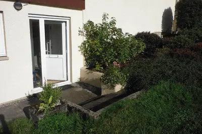 an entrance to a house with a white door at Mingulay, Cuil Bay in Appin