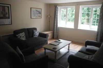 a living room with two couches and a coffee table at Mingulay, Cuil Bay in Appin
