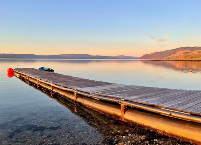 a dock on a body of water at Scallopshell Lodge in Otter Ferry
