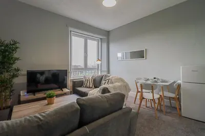 a living room with a couch and a table at Townend Apartment in Dumbarton