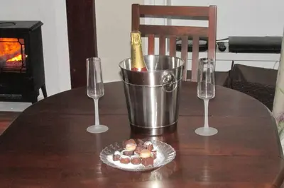 a table with a bottle of champagne and two wine glasses at Old Town 163 in Edinburgh