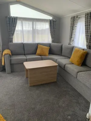 a living room with a couch and a coffee table at The Castleton Sea View 13 in Dunoon