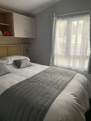 a bedroom with a large bed with a window at The Castleton Sea View 13 in Dunoon