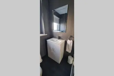 a bathroom with a sink and a mirror at Craiglynn Holiday Apartment Loch Lomond in Balloch