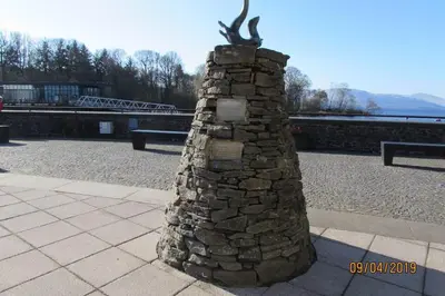 a stone wall with a statue on top of it at Craiglynn Holiday Apartment Loch Lomond in Balloch