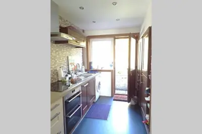 a kitchen with a large window and a sink at Sunny House with views to Edinburgh Skyline in Edinburgh