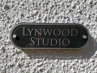 a sign for hywood studio on the side of a building at Lynwood Studio in Oban