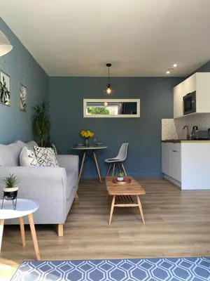 a living room with a couch and a table at Lynwood Studio in Oban